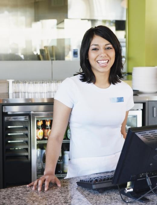 At a small cafe, the hostess may not only greet and seat customers but also operate the cash register.